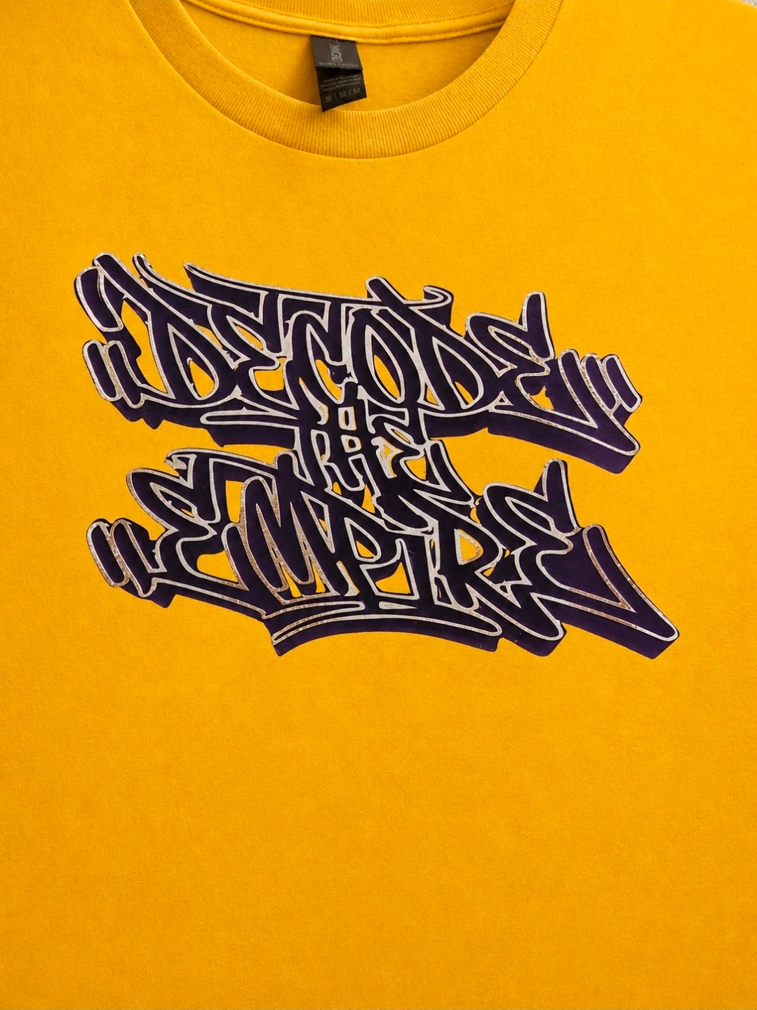 Yellow t-shirt with stylized text design on a plain background